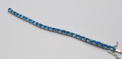 BLUE TOPAZ 5X7 MM OVAL SHAPE STERLING SILVER TENNIS BRACELET
