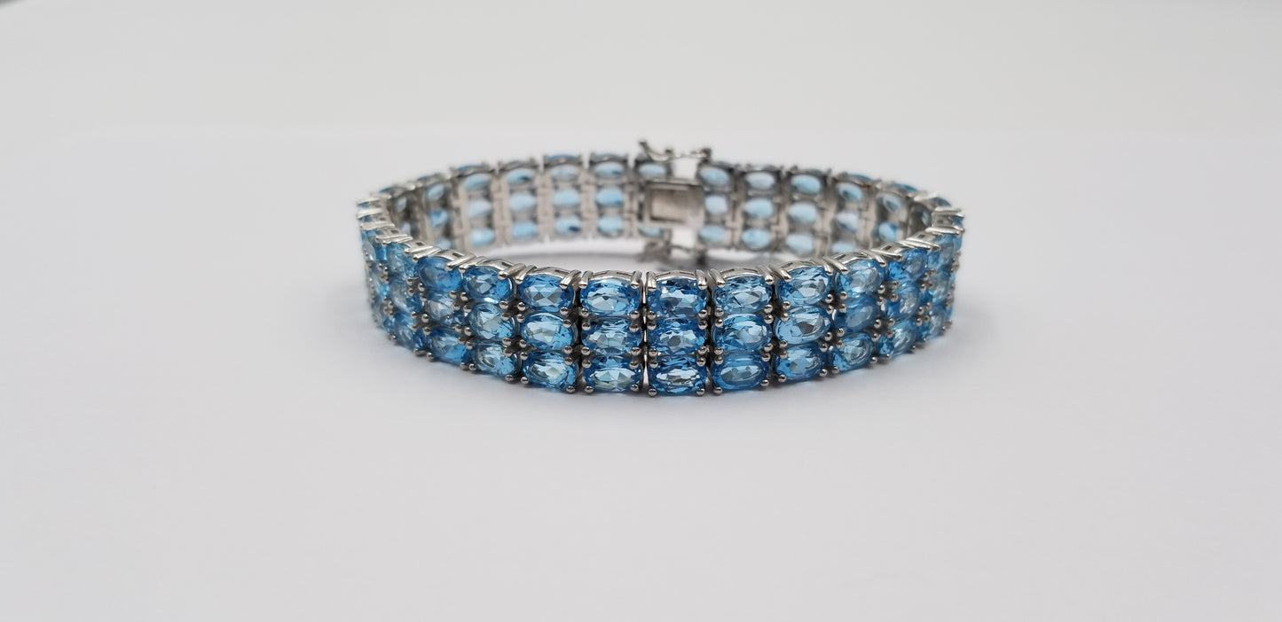 BLUE TOPAZ OVAL SHAPE TRIPLE ROWS STERLING SILVER TENNIS BRACELET