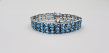 BLUE TOPAZ OVAL SHAPE TRIPLE ROWS STERLING SILVER TENNIS BRACELET