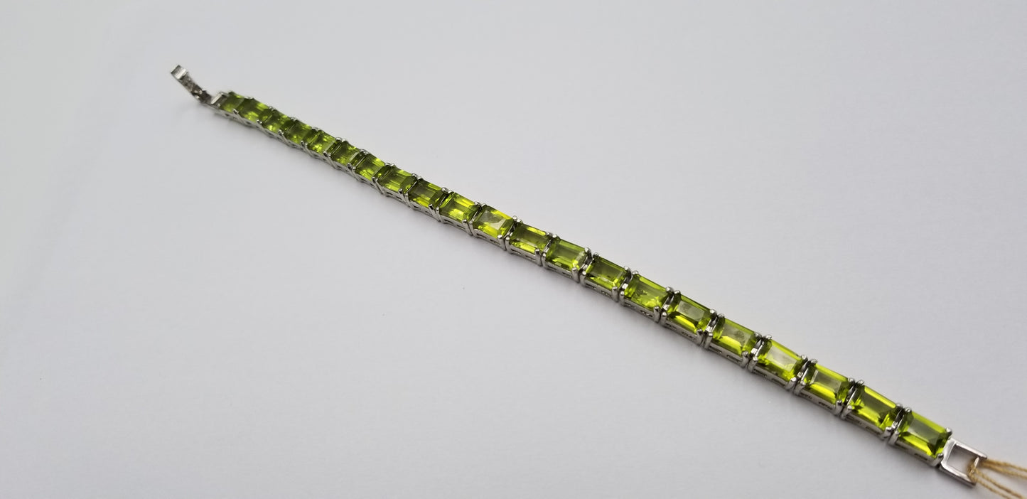 PERIDOTS 5X7 MM EMERALD CUT STERLING SILVER TENNIS BRACELET