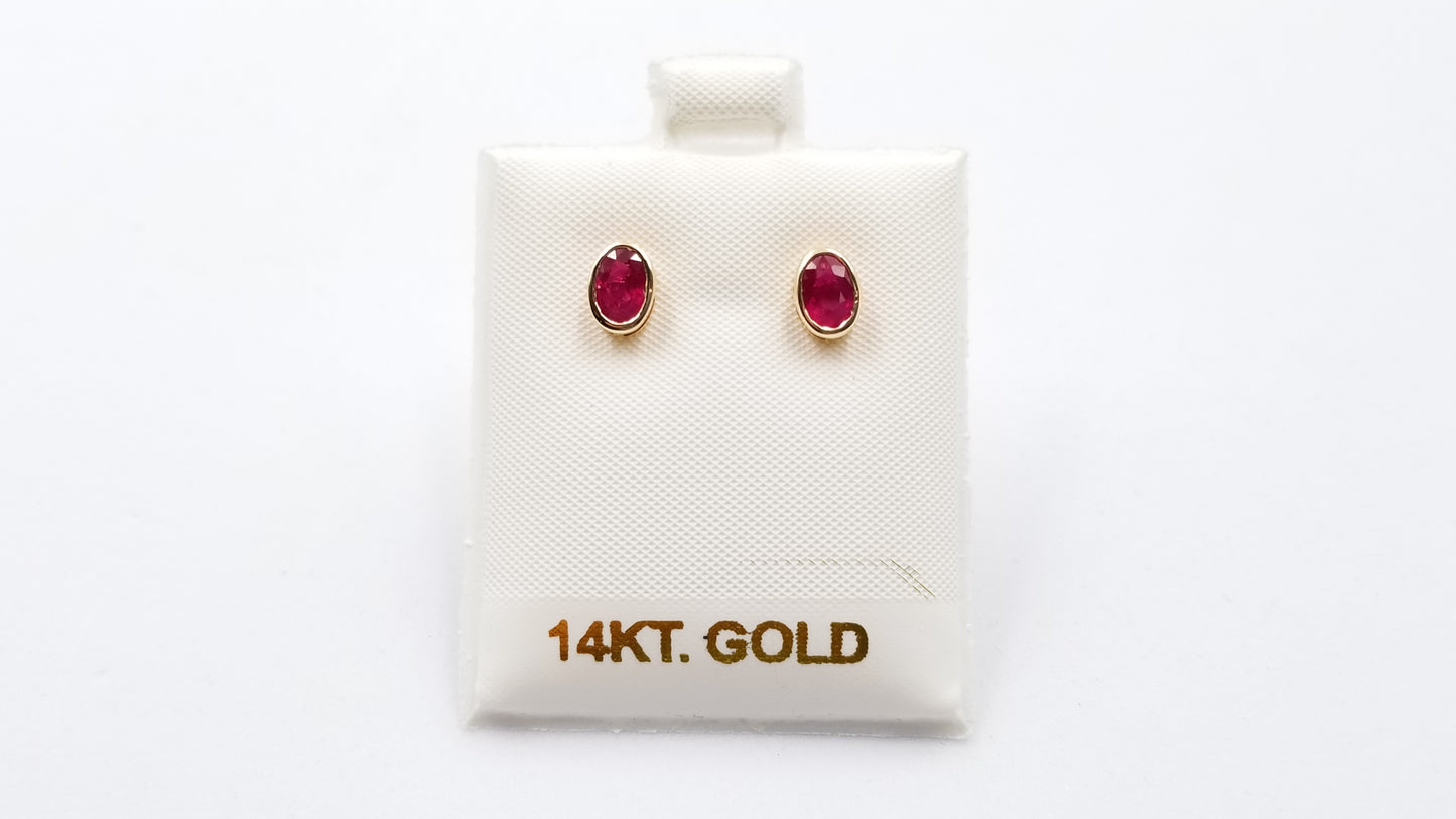 RUBY 5X7 MM OVAL BEZEL SET 14 KT YELLOW GOLD STUDS EARRING