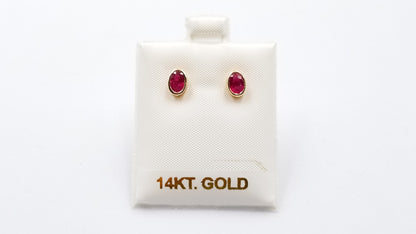 RUBY 5X7 MM OVAL BEZEL SET 14 KT YELLOW GOLD STUDS EARRING