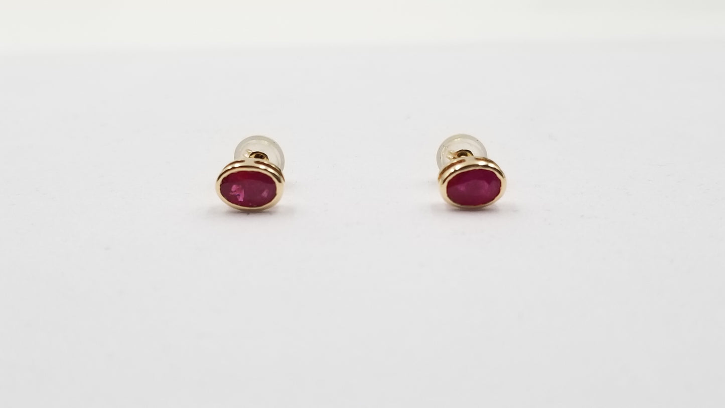 RUBY 5X7 MM OVAL BEZEL SET 14 KT YELLOW GOLD STUDS EARRING