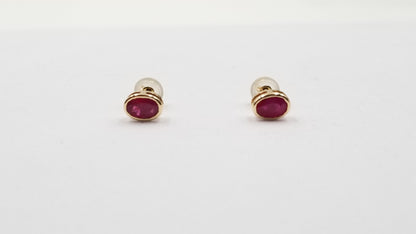 RUBY 5X7 MM OVAL BEZEL SET 14 KT YELLOW GOLD STUDS EARRING