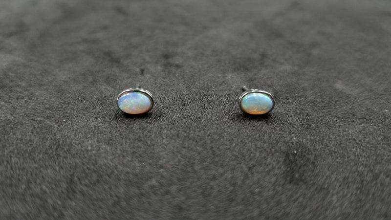 OPAL ( AUSTRALIAN )5X7 MM OVAL BEZEL SET 14 KT WHITE GOLD STUDS EARRINGS