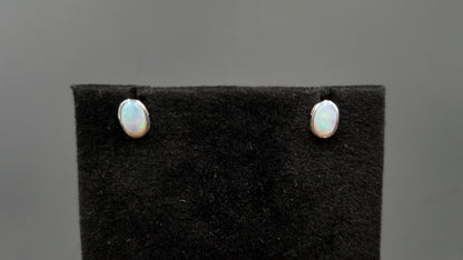 OPAL ( AUSTRALIAN )5X7 MM OVAL BEZEL SET 14 KT WHITE GOLD STUDS EARRINGS