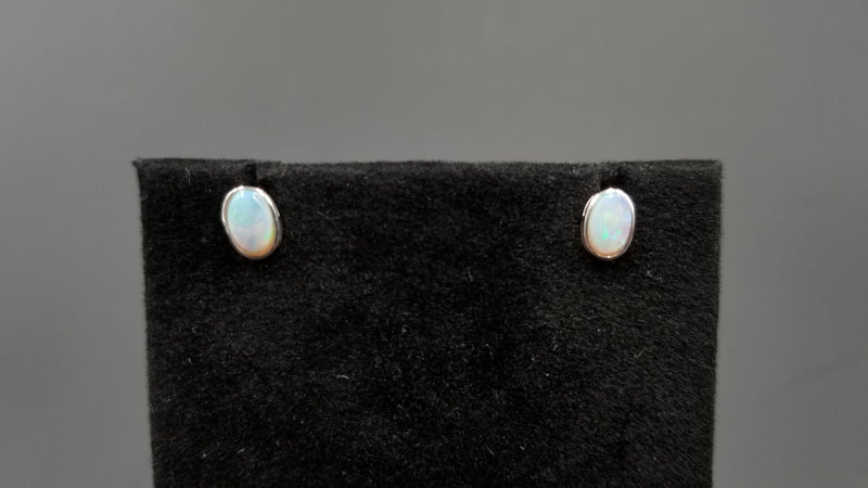 OPAL ( AUSTRALIAN )5X7 MM OVAL BEZEL SET 14 KT WHITE GOLD STUDS EARRINGS