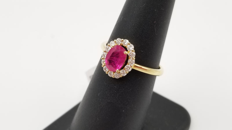 RUBY ( OVAL ) WITH DIAMONDS 18 KT YELLOW GOLD HALO RING