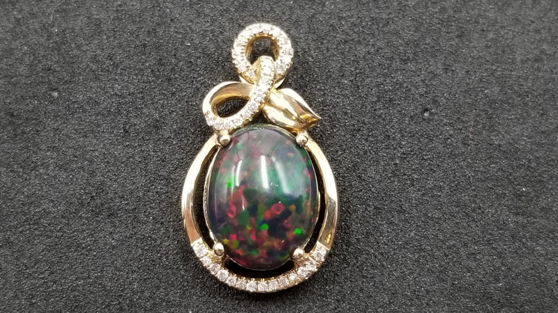 BLACK OPAL ( ETHEOPIAN ) OVAL 8X10 MM WITH DIAMONDS 14 KT YELLOW GOLD PENDANT