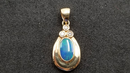 BOULDER OPAL DOUBLET BEZEL SET WITH DIAMONDS 14 KT YELLOW GOLD PENDANT